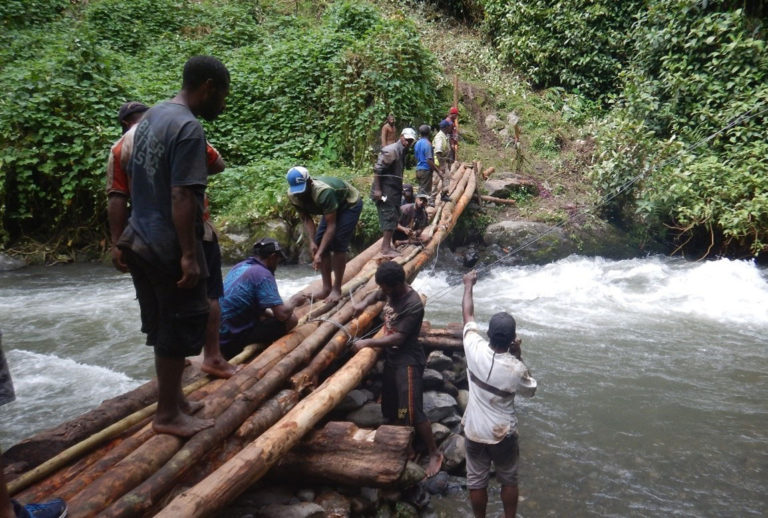 Kokoda Track maintenance - working on a bridge across the river